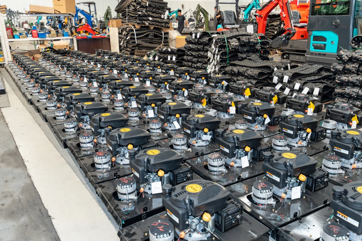 Engine units and tracked components arranged in the workshop.