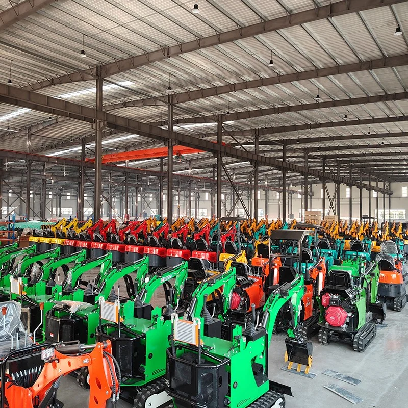 Mini excavators arranged together on the factory floor.