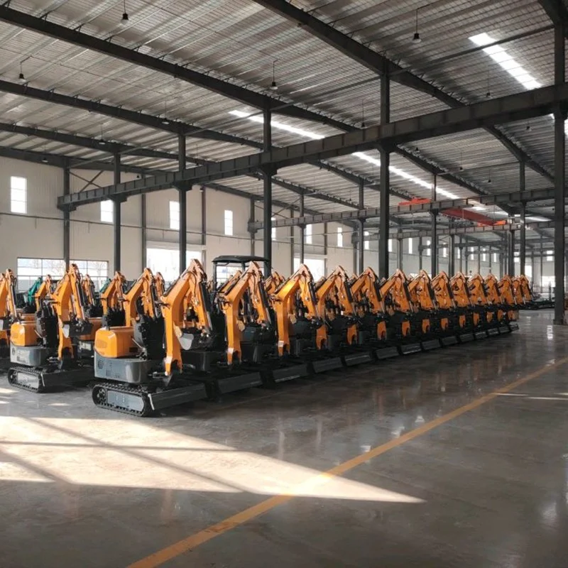 A row of yellow mini excavators with booms and tracks visible on the workshop floor.