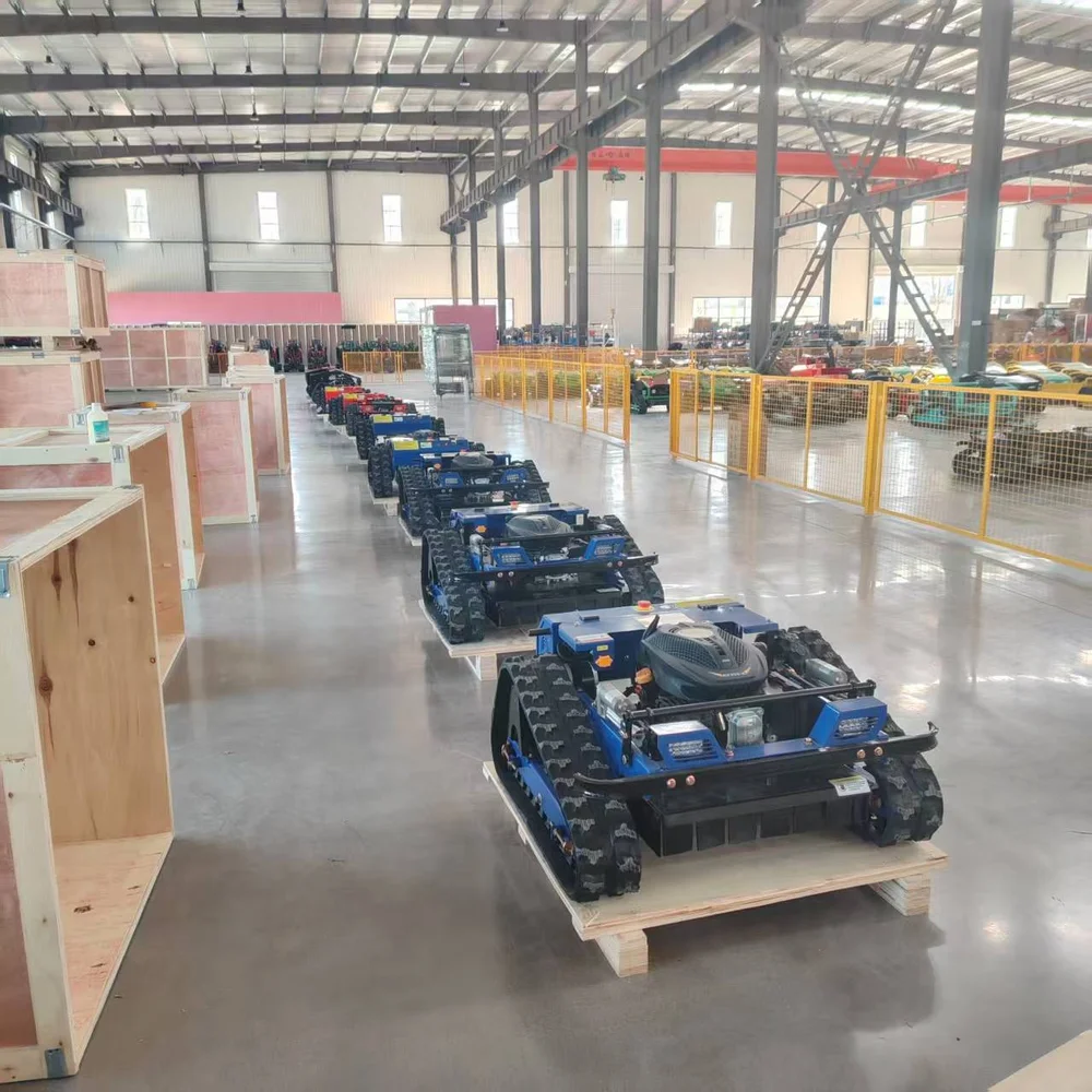 Mowers on wooden pallets beside packing crates in the workshop.