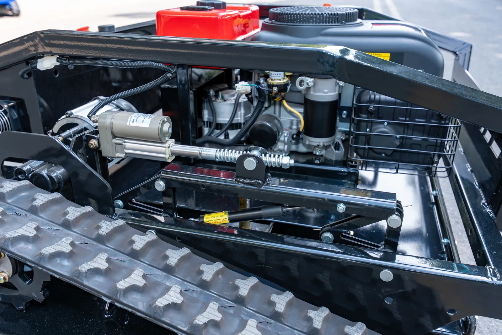 AY-1000 deck lift actuator and linkage beside the engine compartment