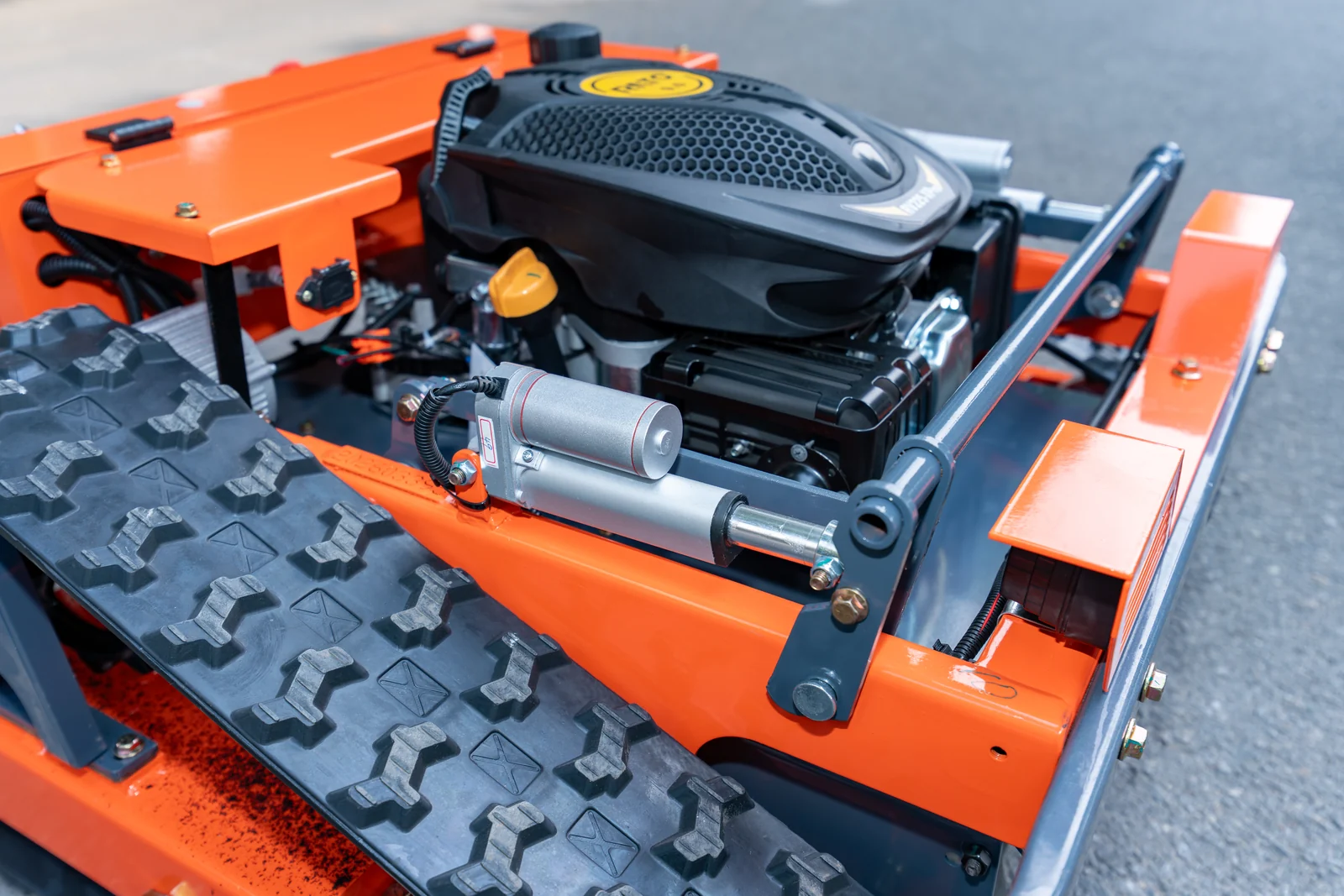 AY-600 cutting-deck lift actuator beside the track assembly